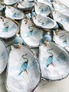 blue and white plates with birds painted on them are arranged in a circle, along with twine strings