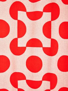 a red and white fabric with circles on it