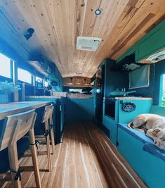 a dog is sleeping on the couch in an rv