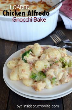 a white plate topped with pasta and broccoli next to a casserole dish