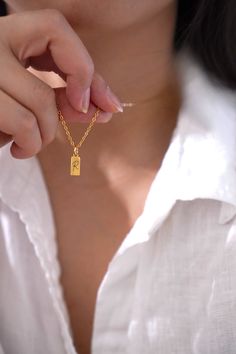 18k Gold Plated Dainty Charm pendant hangs on a sturdy 18K gold plated stainless steel chain. This necklace can be further personalized by engraving your initial or birth flower. See photo listing for options.  You choose your necklace length from the drop-down menu. Model wears 18 inches gold chain. DETAILS Dainty Rectangle Gold Charm measures 5x10mm LENGTH CUSTOMIZATION You may choose your desired length from the drop-down menu or contact me for length customization. QUALITY My designs are tested and proven. My jewelry are made from 316L premium stainless steel, very strong and durable. They are hypoallergenic; very comfortable for sensitive skin and can last for many years and still retain the shiny appearance.  GIFT All items are beautifully gift wrapped! If this is a gift for a specia Gold Rectangular Jewelry With Birth Flower, Gold Rectangular Birth Flower Jewelry, Gold Square Pendant Necklace As Gift For Her, Gold Rectangular Necklace As Gift For Mom, Gold Rectangular Pendant Jewelry Gift For Mom, Gold Rectangular Pendant Jewelry As Gift For Mom, Rectangular Gold Jewelry As Gift For Mom, Rectangular Gold Necklace As Gift For Mom, Rectangular Gold Jewelry Gift For Mom