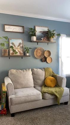 a living room filled with furniture and lots of pictures on the wall above it's couch