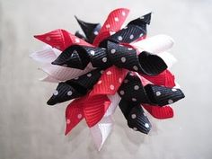 a red, white and black hair bow with polka dots