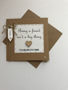 a card with a heart and tag on it that says being a friend isn't a big thing