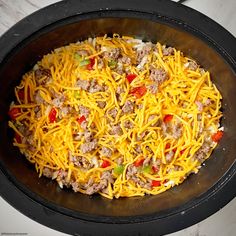 a skillet filled with cheese and ground beef