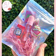 a person holding up a clear bag filled with pink stuff