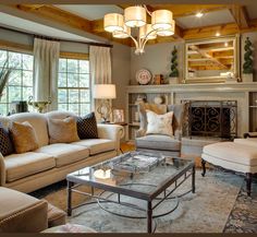 a living room filled with furniture and a fire place in the middle of a room