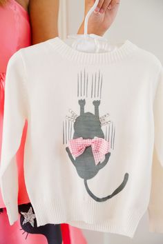 Introducing the purr-fect addition to your little one's wardrobe: the MINI KIDS SCAREDY CAT WHITE SWEATER! Made from soft white knit fabric, this sweater features a playful scared cat design with a cute pink bow. Keep your little one warm and stylish while unleashing their inner feline fun! All orders are currently shipping within 14 business days. To receive item quicker, expedited shipping is available at checkout. **ALL HALLOWEEN ORDERS MUST BE PLACED WITH EXPEDITED SHIPPING TO GUARANTEE DELI Scaredy Cat, Scared Cat, Cat White, White Sweater, Cat Design, Soft White, White Sweaters, Pink Bow, Cute Pink