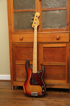 an electric bass guitar sitting on the floor