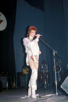 a woman in short shorts and boots on stage