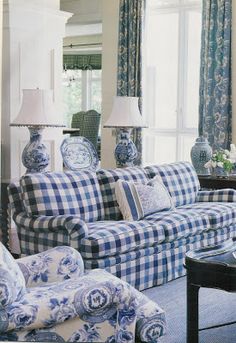 a living room filled with furniture and blue and white decor on top of each other