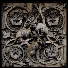 an intricately carved panel with two mice and flowers