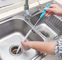 a person is washing their hands in the sink