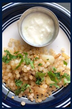 a blue and white plate topped with food next to a bowl of yogurt