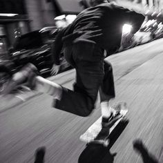 a man riding a skateboard down the side of a street