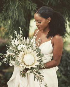 a woman in a white dress holding a bouquet