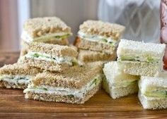 several sandwiches stacked on top of each other next to a glass with a straw in it