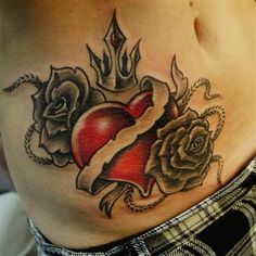 a woman's stomach with tattoos and roses on it