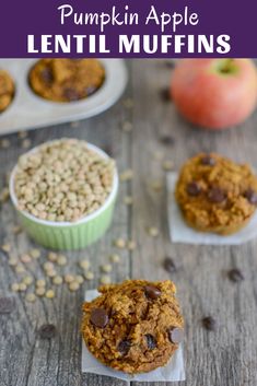 three muffins with chocolate chips and apples in the background