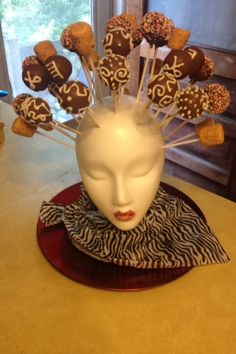 a white head with chocolate covered candies in it