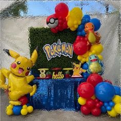 a birthday cake with balloons and pokemon characters