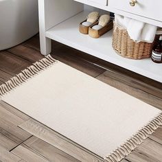 a bathroom with a white vanity and wooden floors