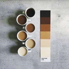 there are coffee cups on the table next to each other and a pantone color chart