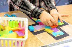 a child is cutting out pieces of paper with scissors