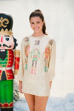 Introducing our NUTCRACKER LONG-SLEEVE GOLD SEQUIN DRESS, the perfect addition to your holiday wardrobe. This stunning long-sleeve dress features a gorgeous gold sequin design that is sure to catch everyone's eye. The cinched wrists add a touch of elegance while the nutcracker trio print adds a playful twist. 'Tis the season to shine! All orders are currently shipping within 14 business days. To receive item quicker, expedited shipping is available at checkout. Gold Sequin Top, Holiday Soiree, Gold Sequin Dress, Sequin Design, The Nutcracker, Holiday Wardrobe, Gold Sequin, Sequin Top, Nutcracker