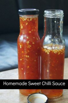 two jars filled with homemade sweet chili sauce sitting on a table next to each other