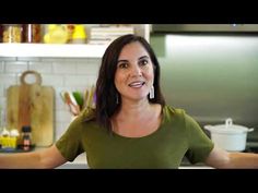 a woman standing in front of a kitchen counter