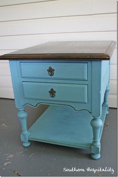 a blue table with two drawers on it