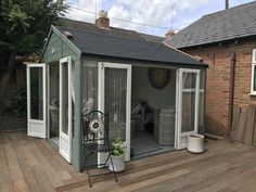 a small garden room with sliding glass doors