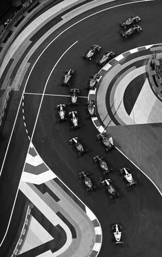 an aerial view of a race track with cars driving around the track and numbers on it