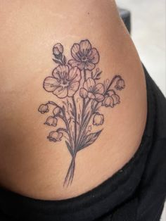 a woman's lower back tattoo with flowers on her stomach and the bottom part of her body