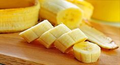 sliced bananas sitting on top of a wooden cutting board