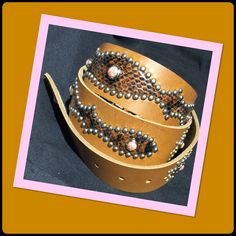 "1940s style western biker belt  38\" waist (36\" to 40\") 1940s style brown leather silver tone studded rockabilly western biker belt with brown snakeskin inlay.  38\" waist Made in Southern California these belts have been manufactured to the highest standard using impeccable craftsmanship. The belts are hand made with the period correct hardware and leather with either stingray, snake or lizard inlay.  Classic Vintage brown leather silver tone studded rockabilly western biker belt ( features contrasting brown snakeskin inlay ) Waist (36\" to 40\") The black leather belt has some embossed details. This classic vintage studded belt is made of genuine leather and accented with silver tone studs with pink stones. The belt features brown snakeskin inlay. This is a copy of a 1940s motorcycle Festival Leather Concho Belts, Vintage Brown Embroidered Belt, Brown Embroidered Belt Buckles For Western-themed Events, Leather Concho Belts For Festivals, Western Leather Belts For Festivals, Western Style Leather Belts For Festivals, Adjustable Western Belts For Festivals, Western Adjustable Belts For Festivals, Western Style Adjustable Belts For Festivals