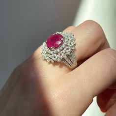 18KT White Gold Oval Ruby + Pave Diamond ring Size 8 Can be resized for an additional fee Large Statement Ring Lovely intricate design This an absolutely lovely attention getting piece! Round and Baguette Diamonds with Oval Faceted Ruby Ring. Approx 4.83 CT Ruby 10.7 x 9.9x 5.7 mm 2.20 CT Diamond Approx 9.8 grams 18KT Stamped Abrasions to the Ruby, which could be polished out by a stone cutter. We can quote for that if need b3, but this ring is so pretty, it really does not need. Check out all o Luxury Oval Ruby Diamond Ring, Luxury Oval Ruby Ring, Exquisite Oval Ruby Ring Gia Certified, Luxury Ruby Ring With Oval Center Stone, Luxury Oval Ruby Ring With Center Stone, Dazzling Oval Ruby Ring With Diamonds, Elegant Gia Certified Oval Ruby Ring, Elegant Gia Certified Halo Ring, Luxury Marquise Ruby Ring For Wedding