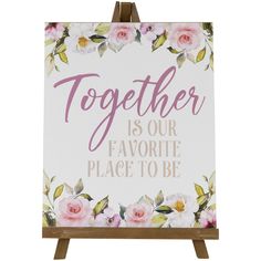 a sign that says together is our favorite place to be with pink flowers on it