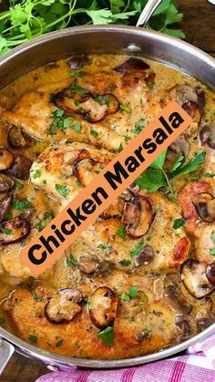 chicken marsala with mushrooms and parsley in a pan on a wooden table top