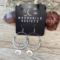 "These handmade earrings feature silver plated brass circles and moon phase connectors with crescent moon charms. They are 2.7\" long and lightweight when worn." Nickel-free Half Moon Bohemian Jewelry, Bohemian Half Moon Nickel-free Jewelry, Crescent Moon Phase Earrings For Festivals, Crescent Moon Phase Festival Earrings, Nickel Free Moon Shaped Jewelry For Festival, Bohemian Half Moon Charm Earrings, Silver Moon Earrings For Festivals, Silver Sun And Moon Design Half Moon Earrings, Silver Half Moon Earrings With Sun And Moon Design