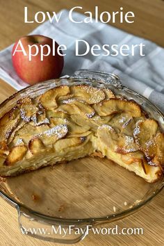 a close up of a pie on a wooden table with an apple in the background