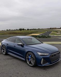 a blue car is parked in the parking lot