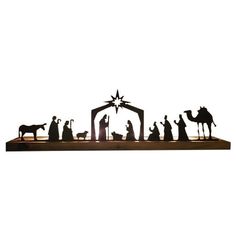 a nativity scene with the birth of jesus and three wise men in silhouettes