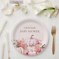 a baby shower plate with flowers and pumpkins on it next to utensils