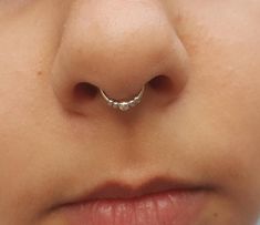 a woman with a nose ring on her nose