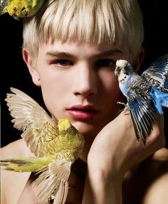 a woman with two birds on her head and one bird sitting on her shoulder,