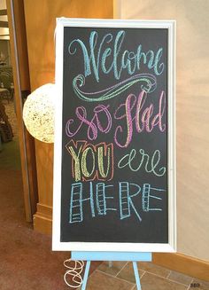 a chalkboard sign with the words welcome to you here