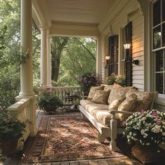 the porch is decorated with flowers and plants on it's sides, along with an area rug