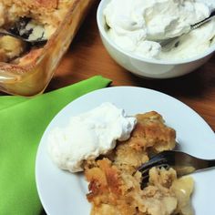 a piece of pie on a plate with whipped cream and a fork next to it